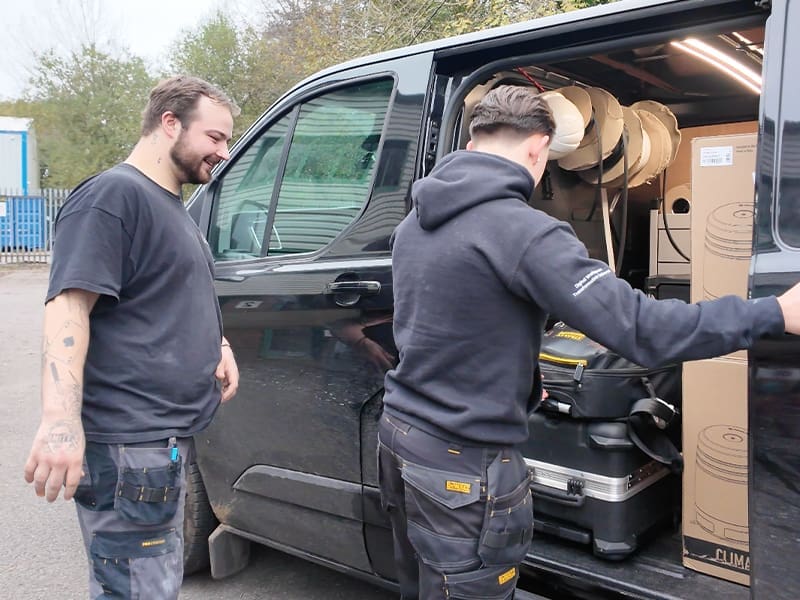 couple of men loading a van with boxes